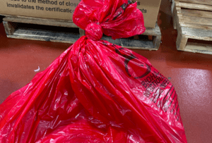 red biohazard bag tied properly shut