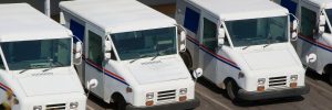 Row of U.S. postal mail delivery trucks